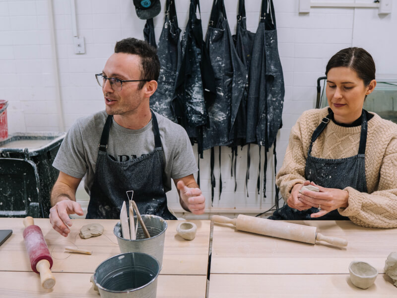 A couple making coffee cups