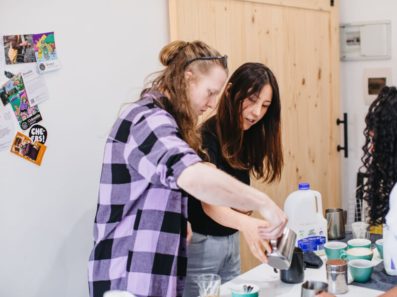 A group of people making coffee together at a barista course