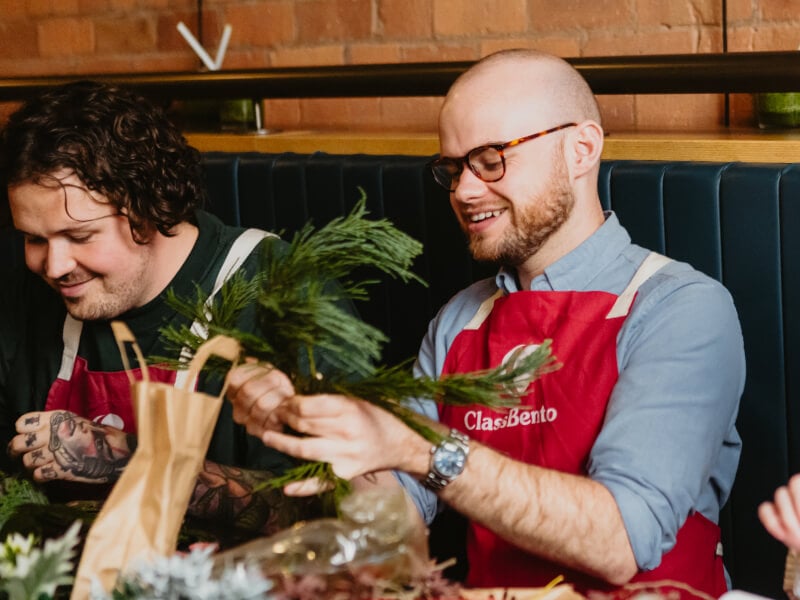 Two colleagues working with plants and laughing together