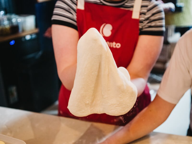 Cooking students works pizza dough at a Melbourne cooking class