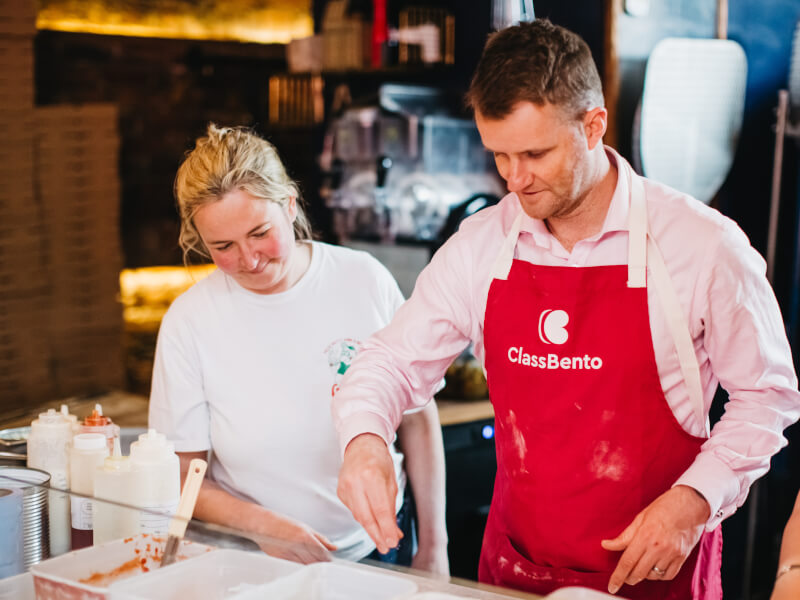 People making pizza together