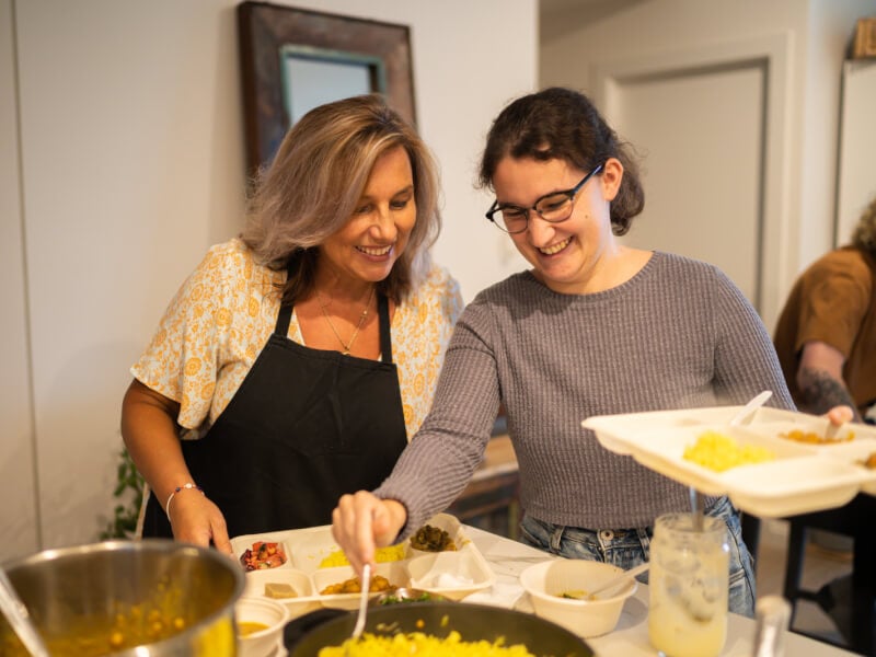 Mother and daughter eating the food they cooked at cooking class