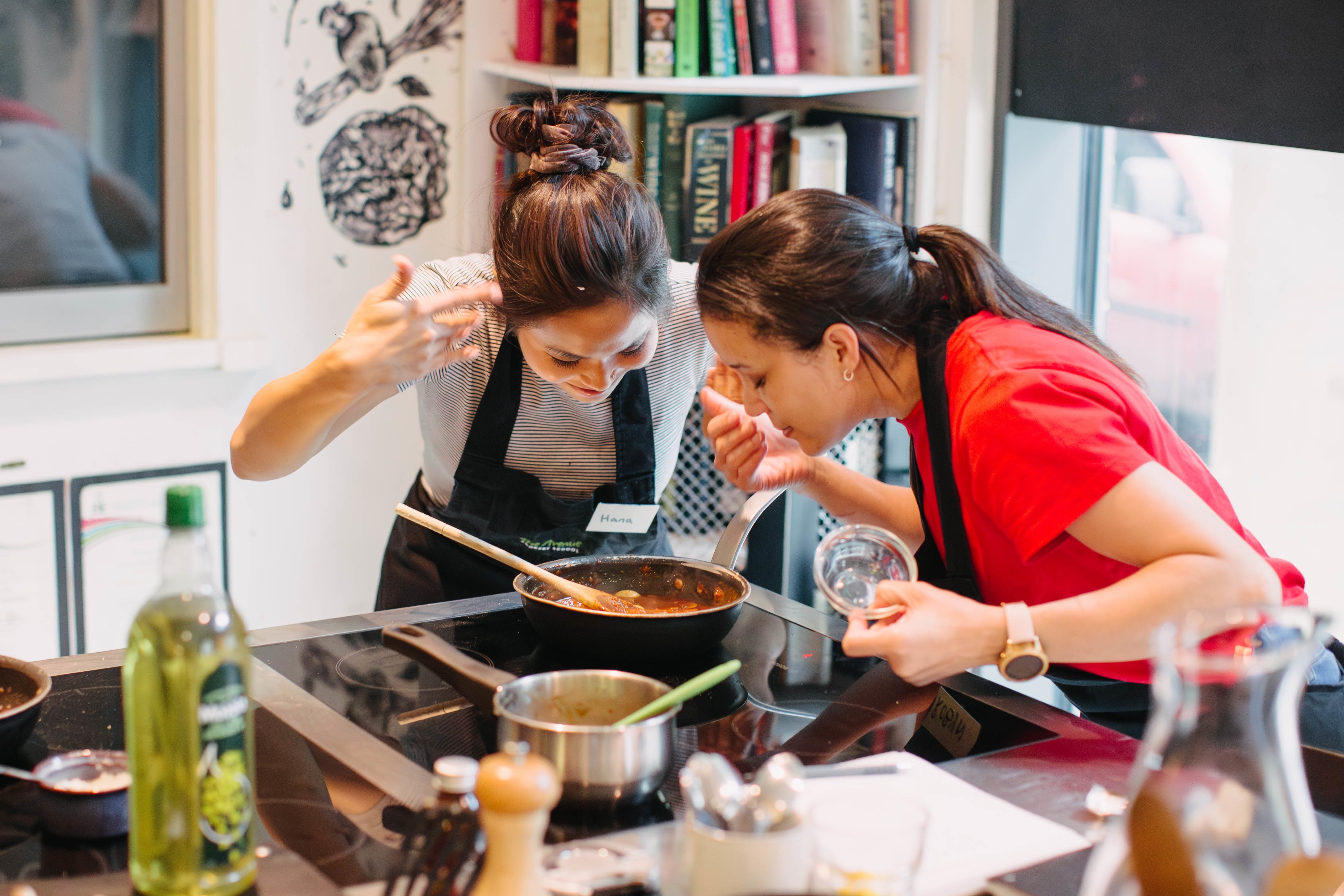 Friends in a cooking class enjoy the scent of their festive food