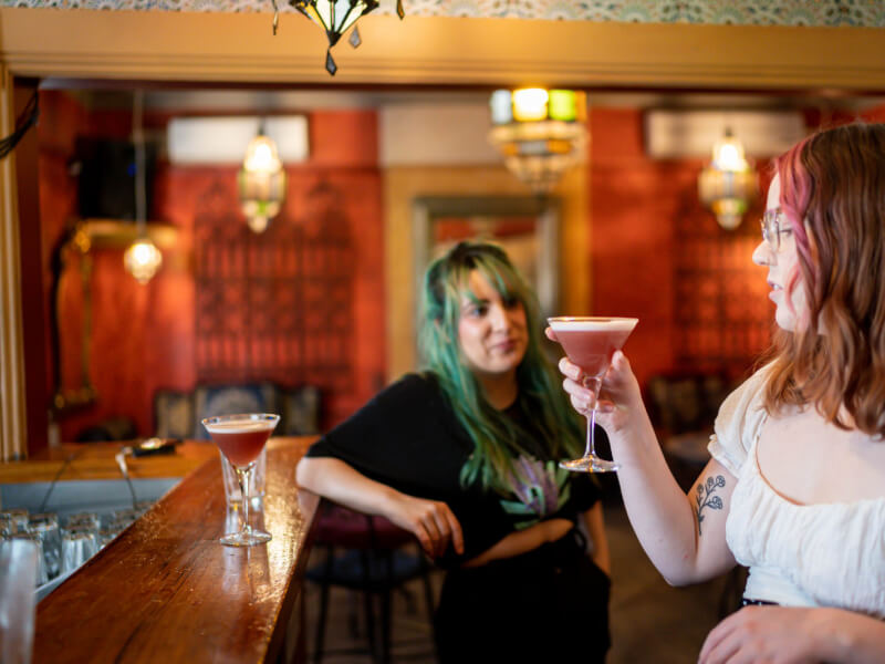 Two colleagues drinking cocktails they made