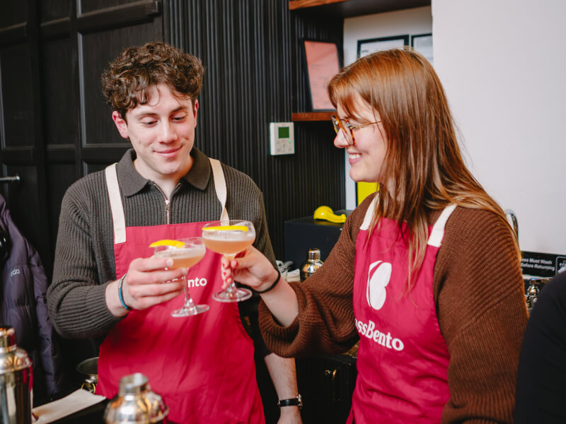 A couple clink their glasses at a cocktail class