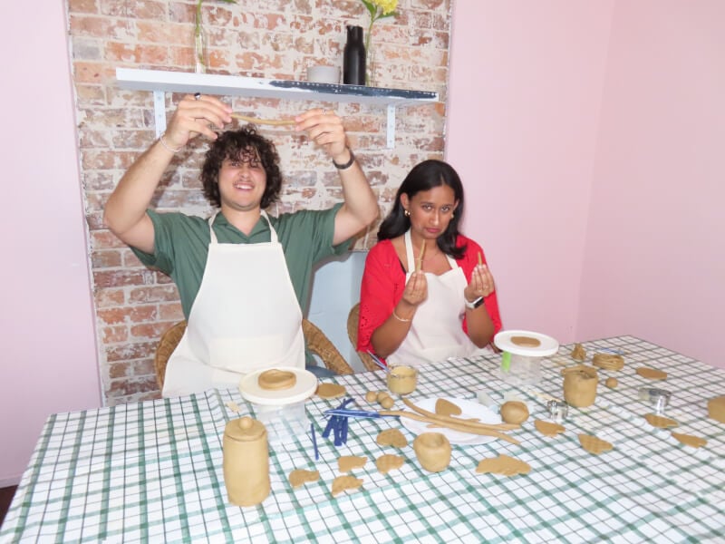 A couple on a date at a pottery class