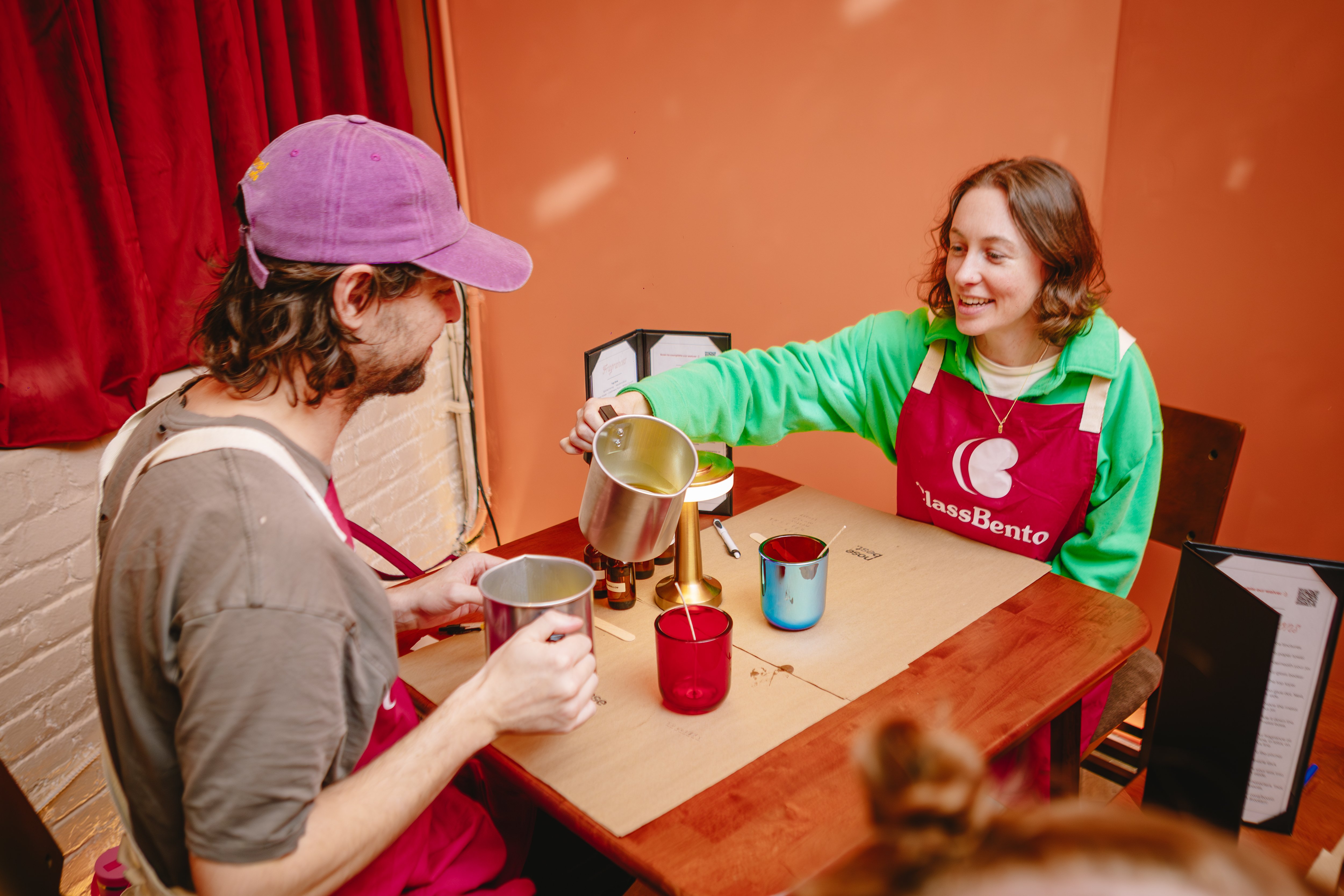 A couple enjoy a screen free date night with candle making class