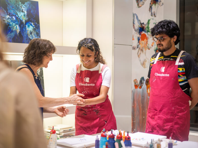 A couple do a paint pouring class together as a date idea