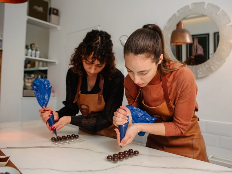 A couple make chocolate truffles together