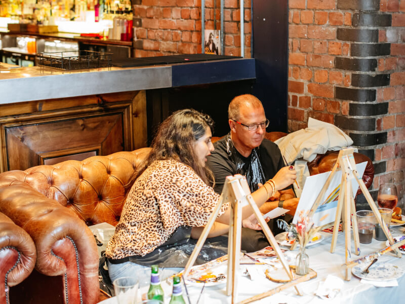 A couple painting at an art class together