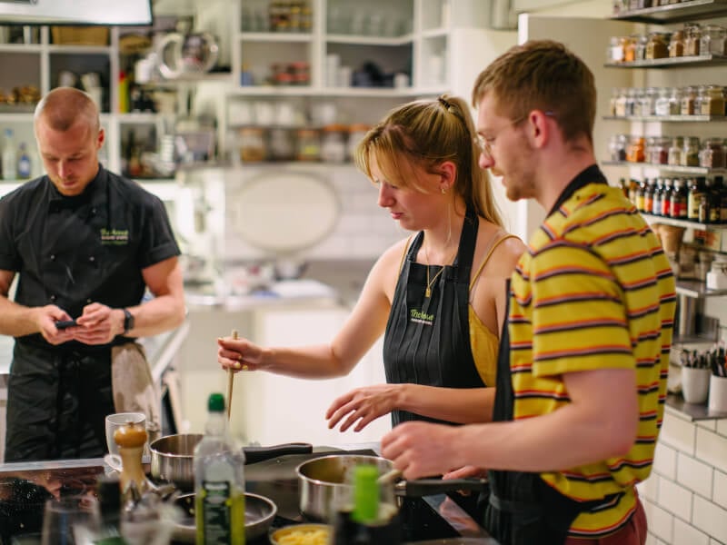 Man and woman cooking at a couples cooking class