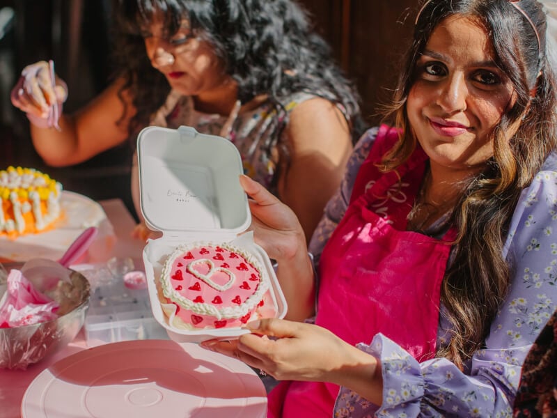 A woman shows off her cute decorated cake