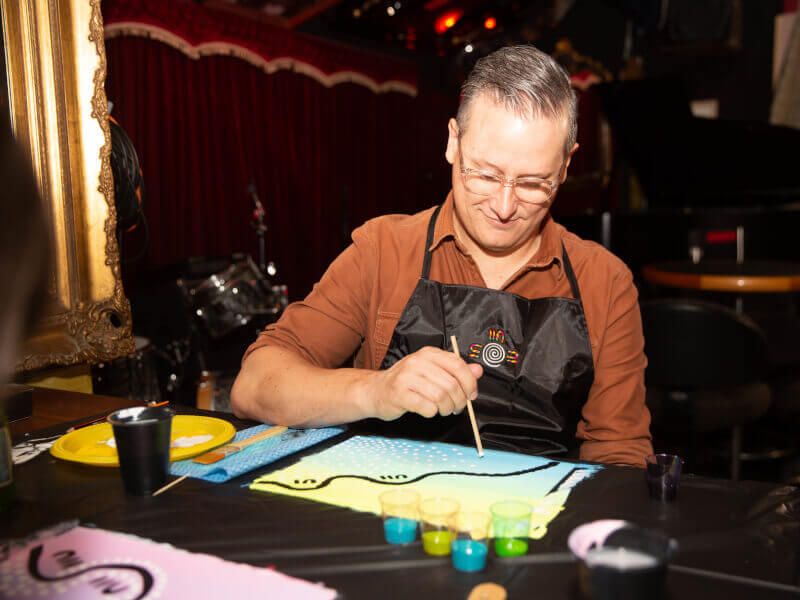 A father enjoys a painting class