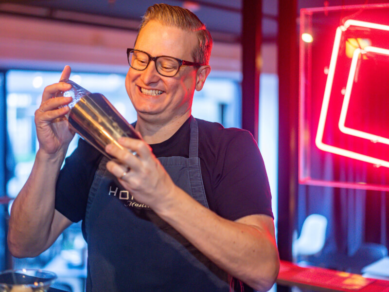 A man making a cocktail in a shaker