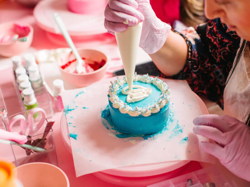 A woman decorating a cake for Mother's Day