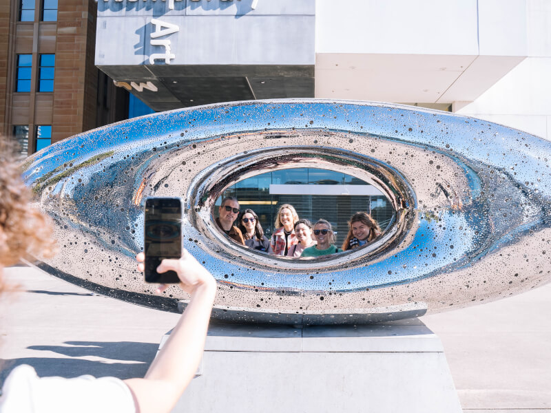 Group photography class taking unique shot of sculpture