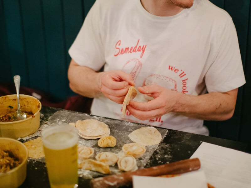 A man making various dumplings at a cooking class he was gifted