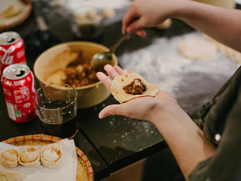 Dough being stuffed at a dumpling making class