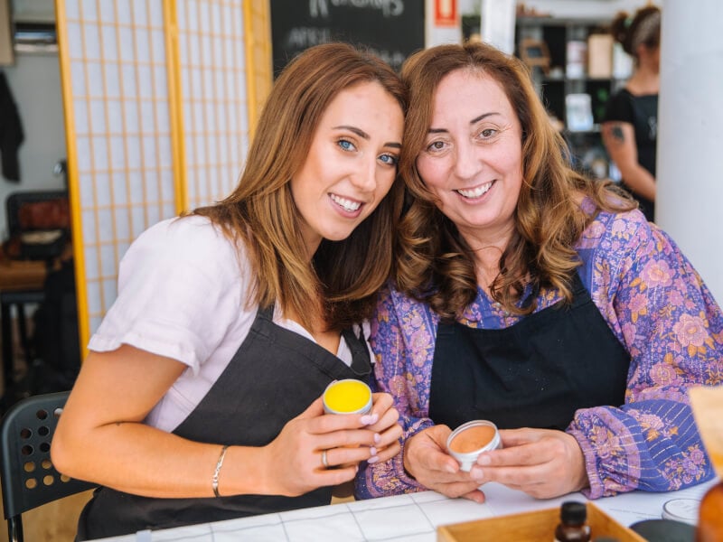 A mother and her daughter hold their handmade skincare