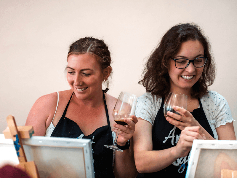 Two girlfriends at a paint and sip