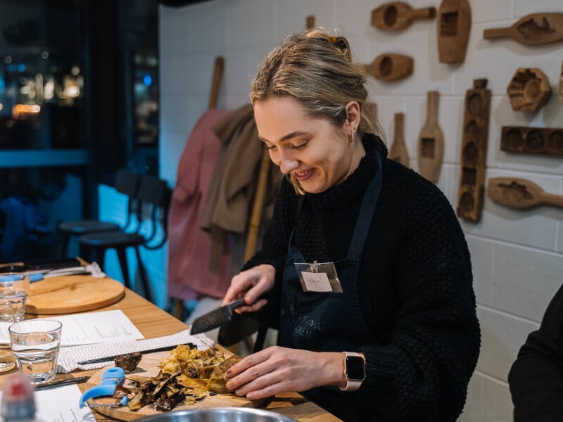A woman preps eggplant at an Asian cooking class