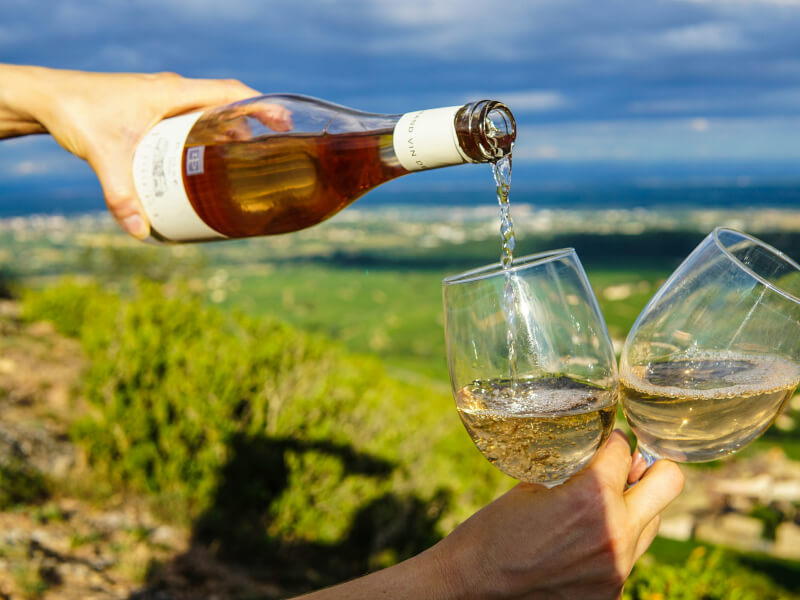 Person pouring wine in a glass