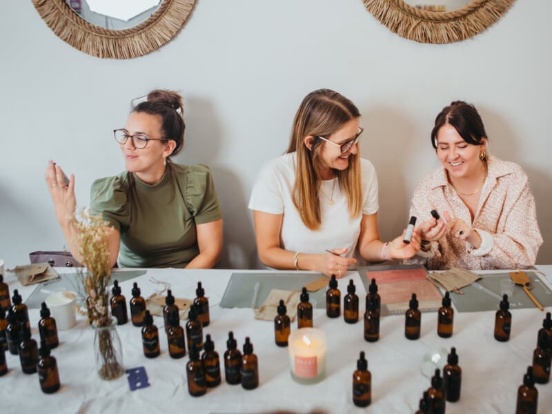 Women surrounded by essential oils at a perfume making class for hens parties