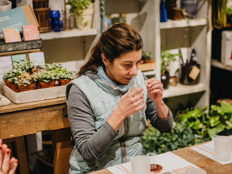 A woman making candles with essential oil