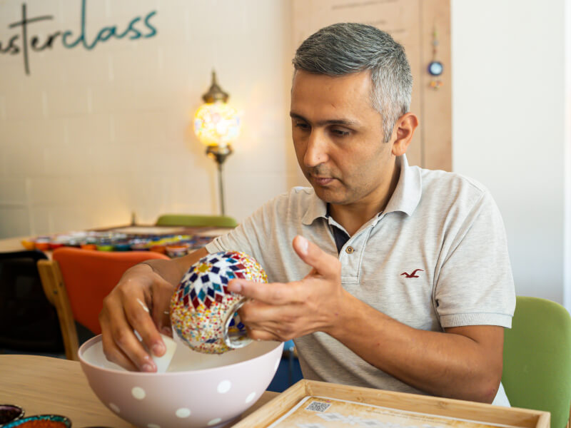 Man making his own Turkish mosaic lamp