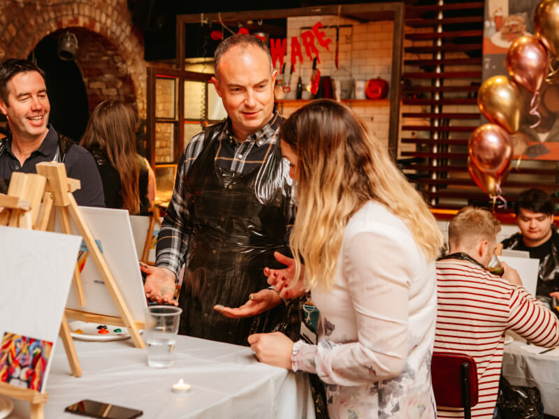 People talking together at a painting class