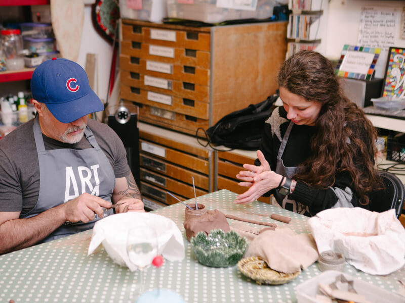 A father and his daughter do a pottery workshop together