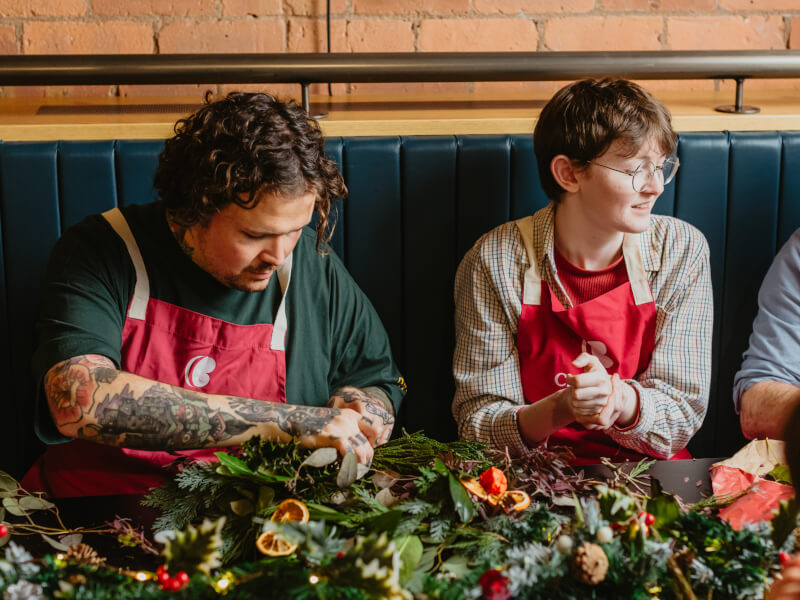 Friends get together at a Christmas wreath making class