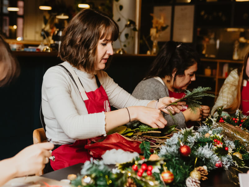 Woman makes a festive Christmas wreath