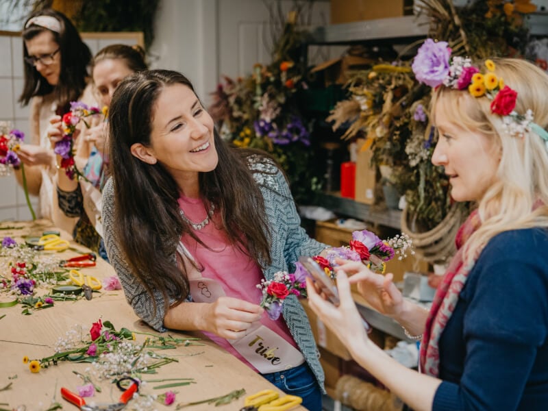A group of women celebrating with flower crowns