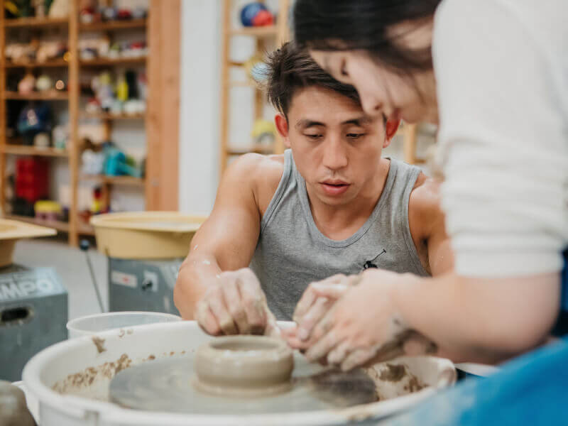 A man with his hands on the pottery wheel