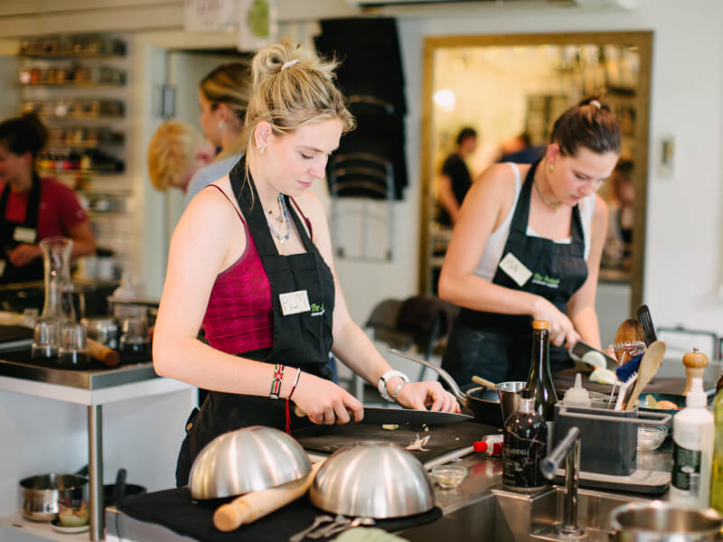 Two women attending a cooking class together