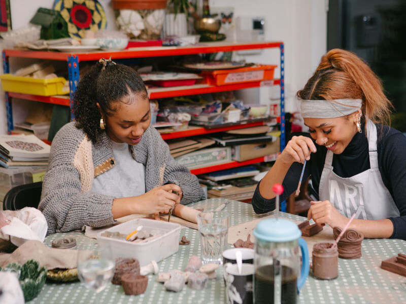 Two friends enjoying a pottery class