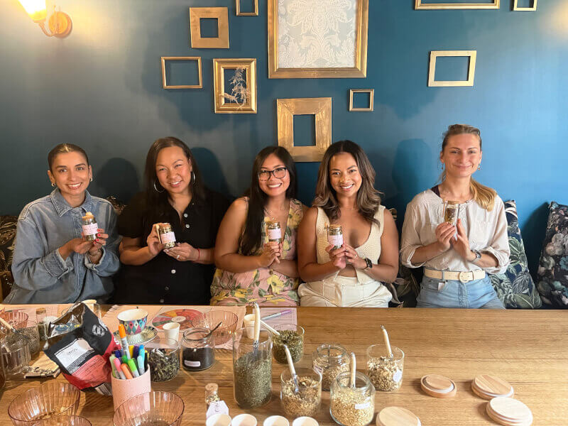 A group of friends celebrate with a tea blending experience gift