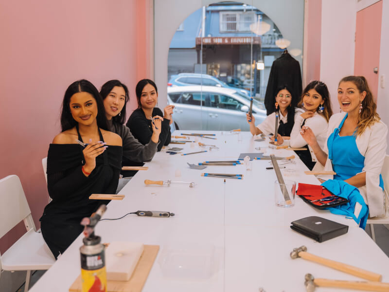 Group of friends making earrings for a hens party activity