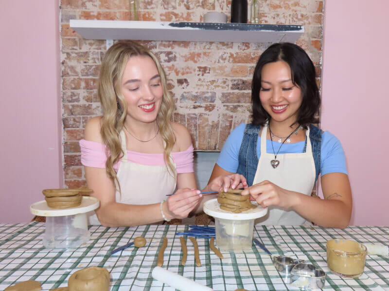 Friends making mugs together