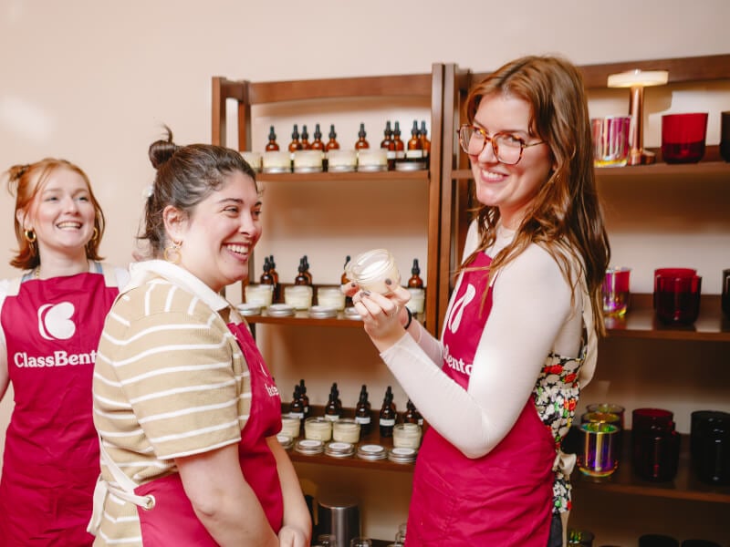 Two friends with candles at a winter workshop