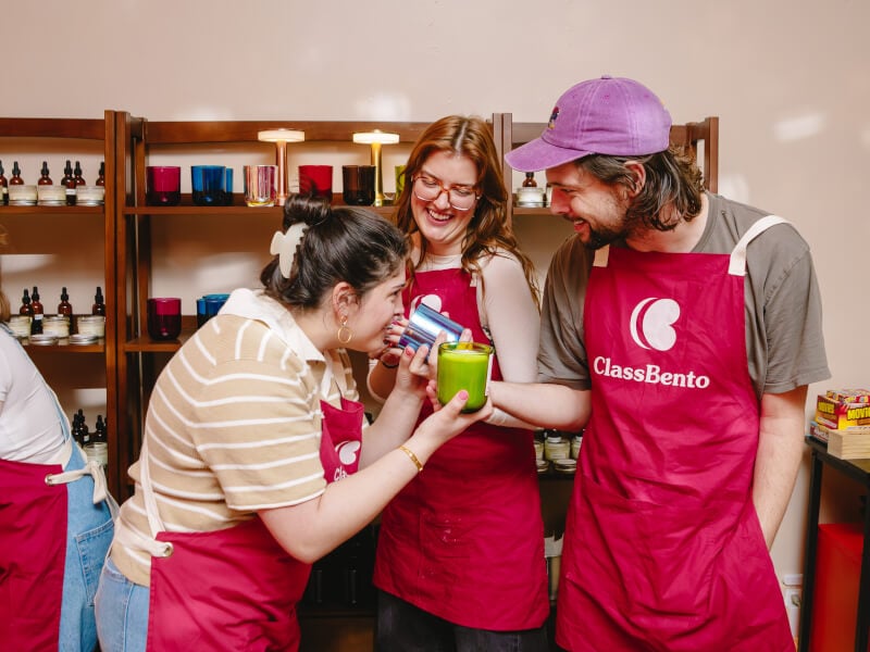 Small group of friends smell each others handmade candles