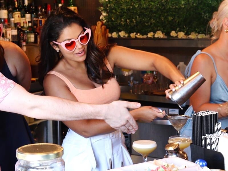 A woman making cocktails at a bar in Surry Hills