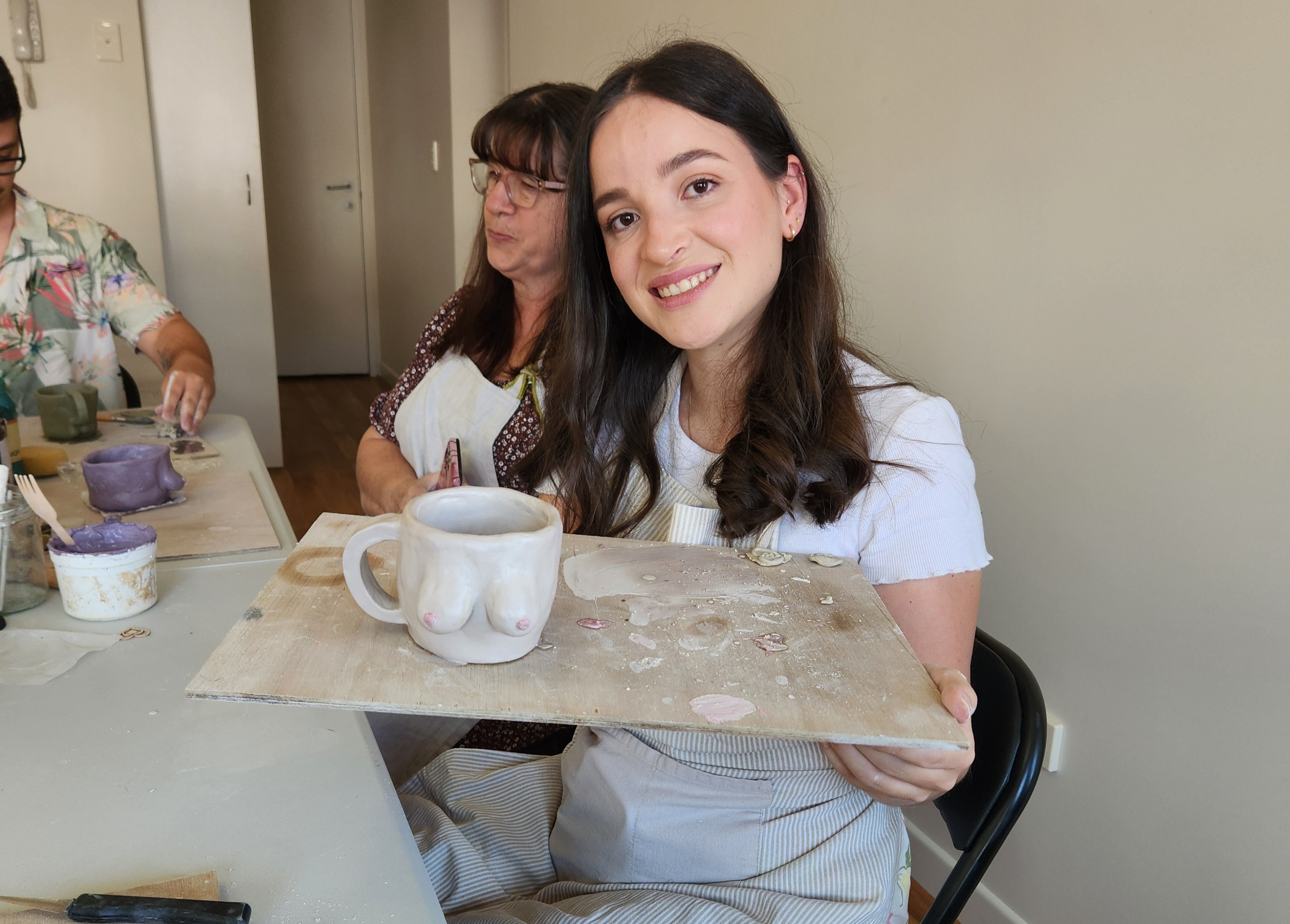 A woman shows off her funky boob mug