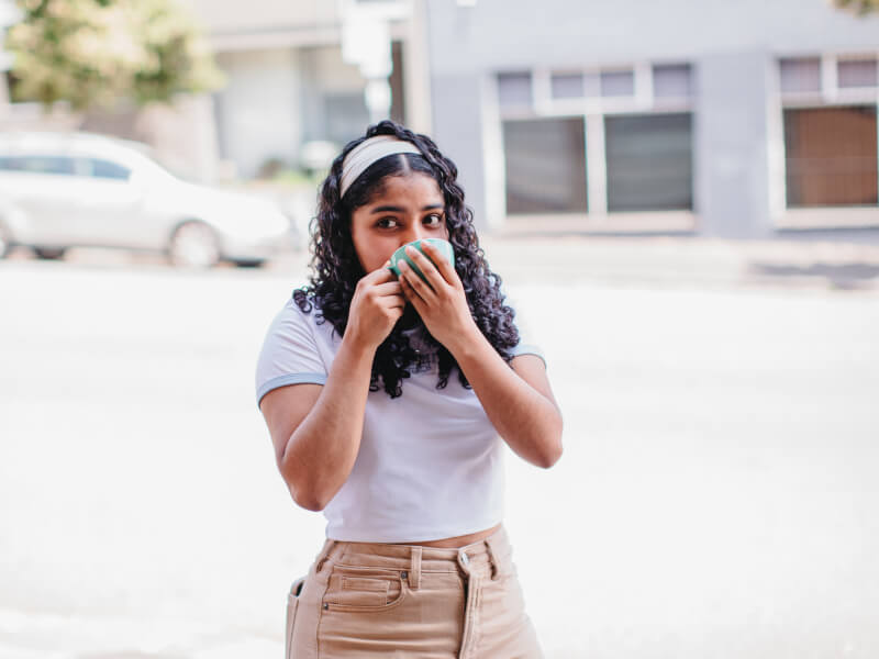 Girl drinks coffee she made at barista class she was gifted