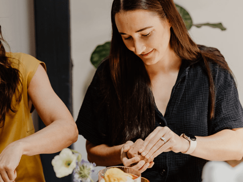 woman hand-building a mug