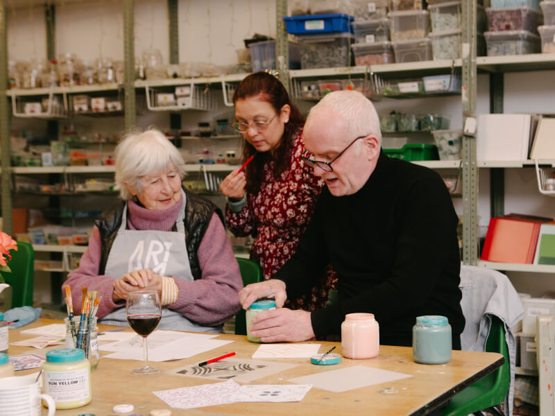 Elderly people painting ceramics