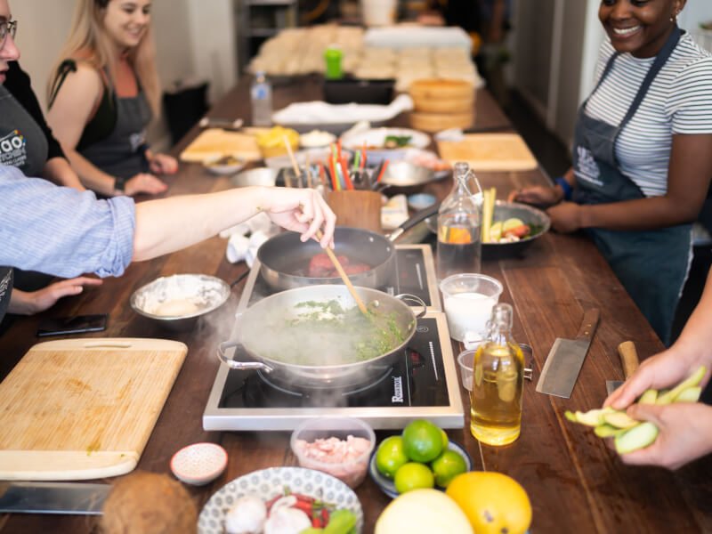A group of students cooking at a cooking class