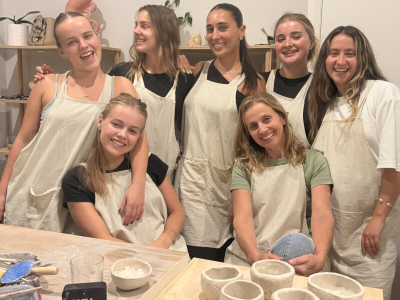 A group of friends at a pottery class in Newport