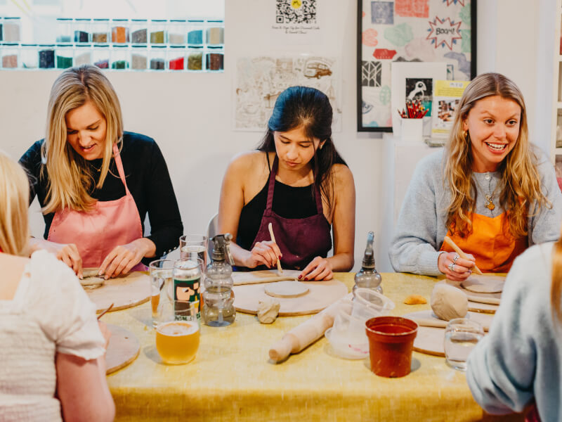 A group of teammates building pottery in a workshop